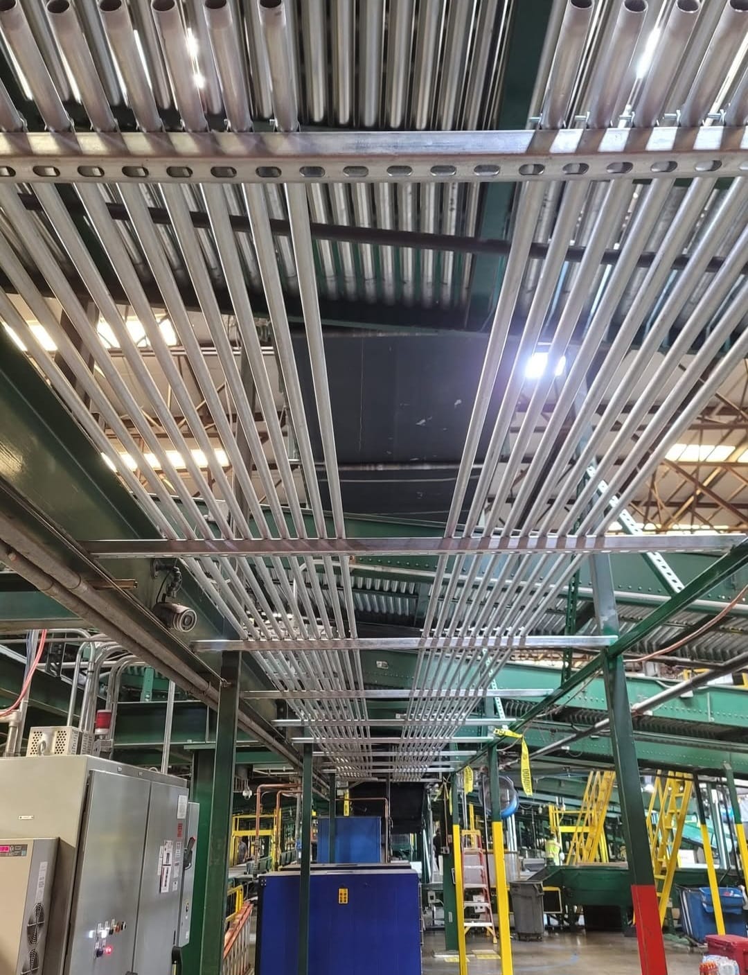 Industrial Electrical Contractor — Stacked conduit rack across production floor